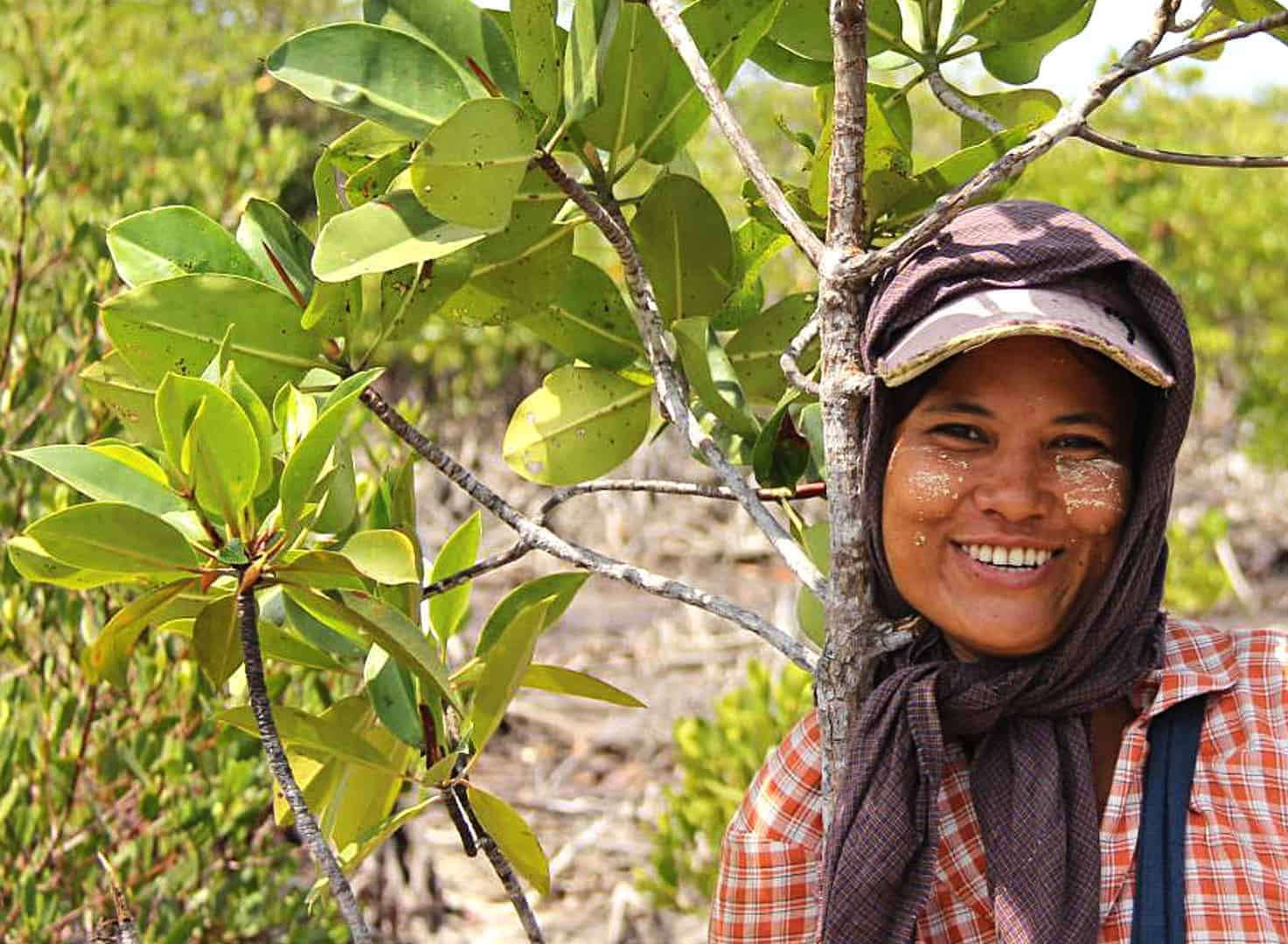 Woman smiling, tree