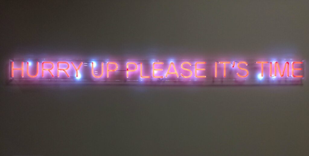 "Hurry up please it's time" shining sign. artpiece at the COP26