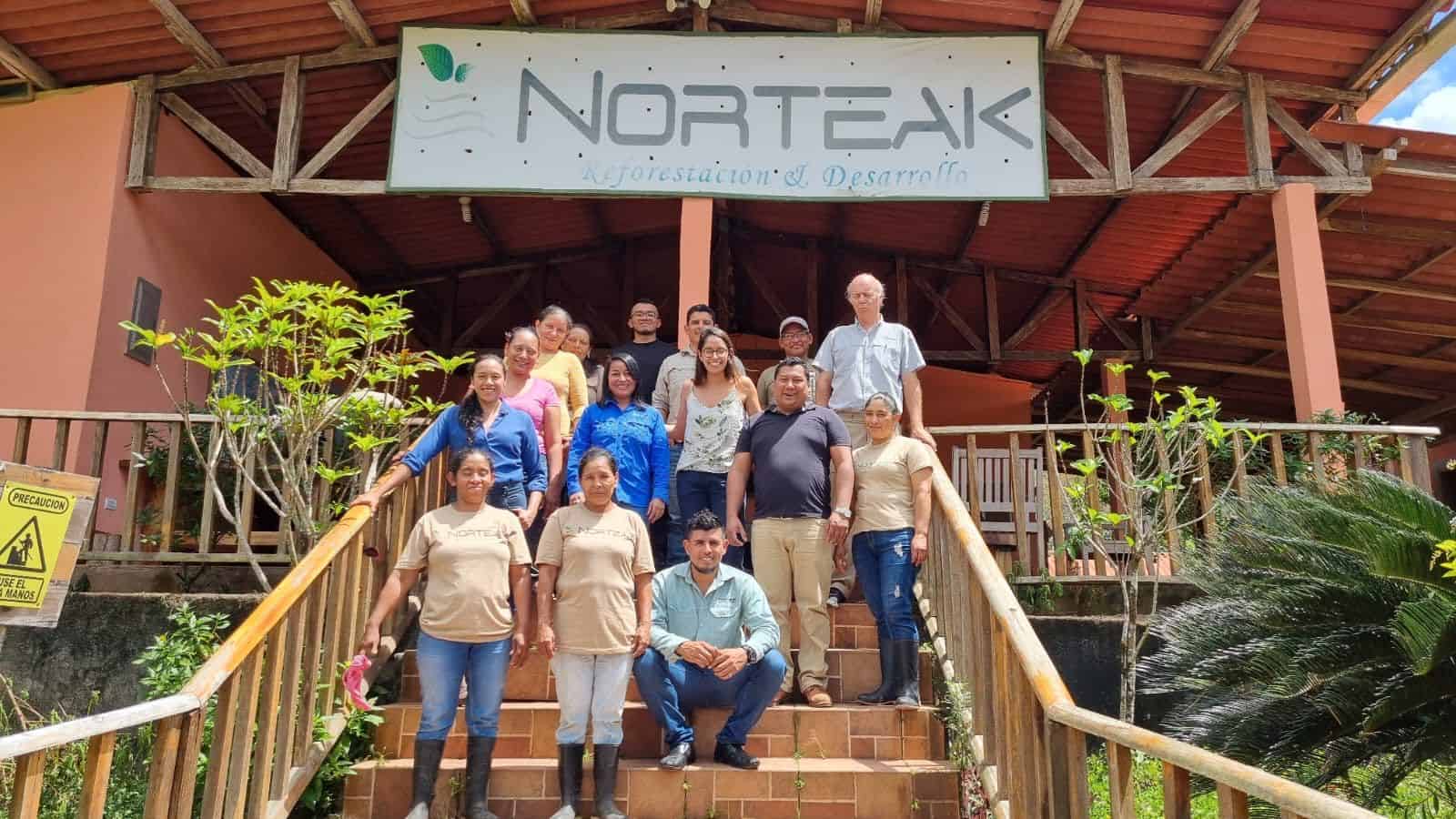 Norteak team, group picture infront of a wooden cabin