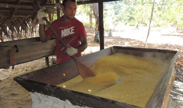 Man stirring grains